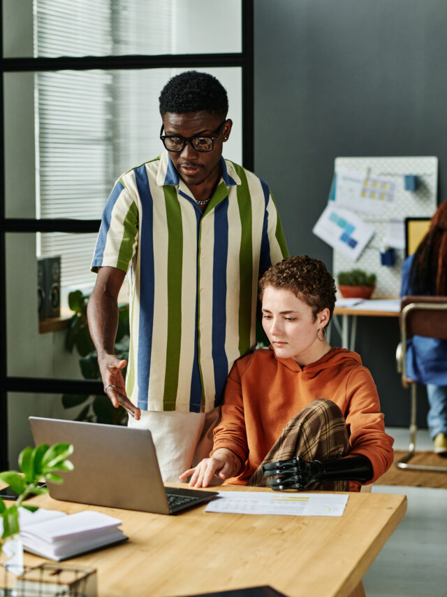 Young confident businessman explaining data to colleague